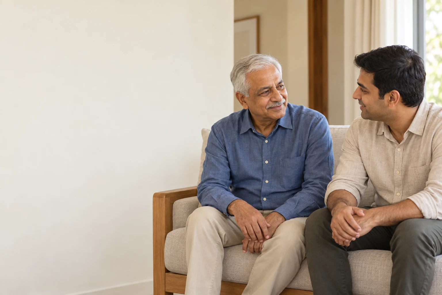 Adult son and senior father discussing aging in place at home