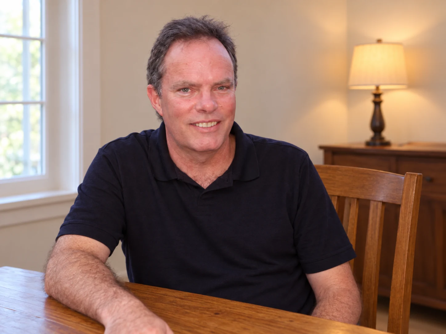 Joe Janisch, founder of Triangle Home Safety, seated at a table in a home interior