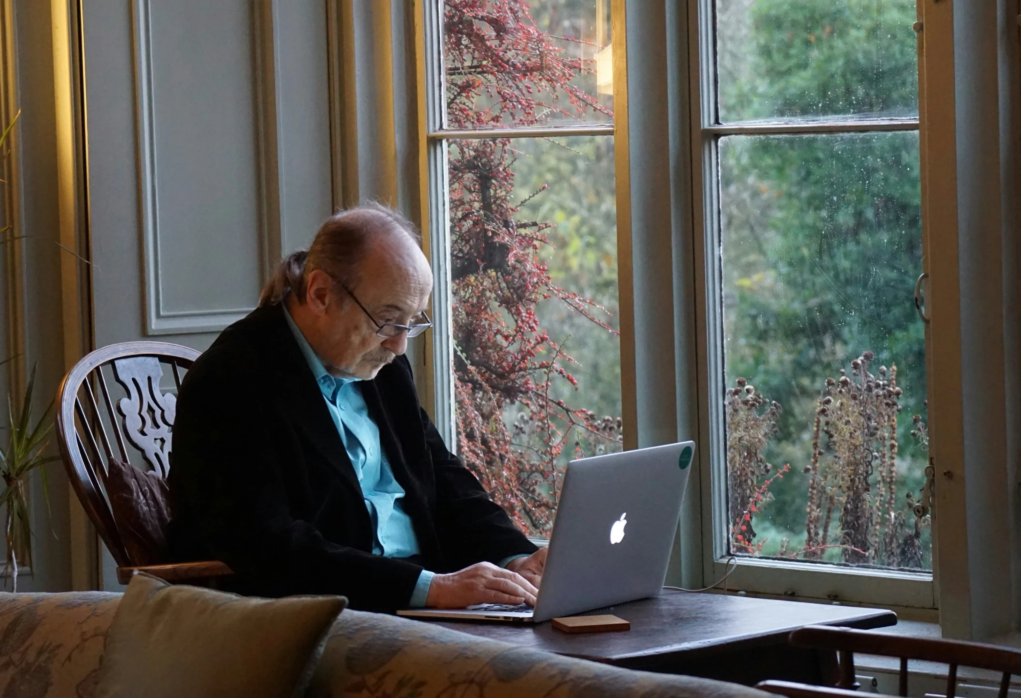Senior homeowner exploring aging in place resources on a laptop