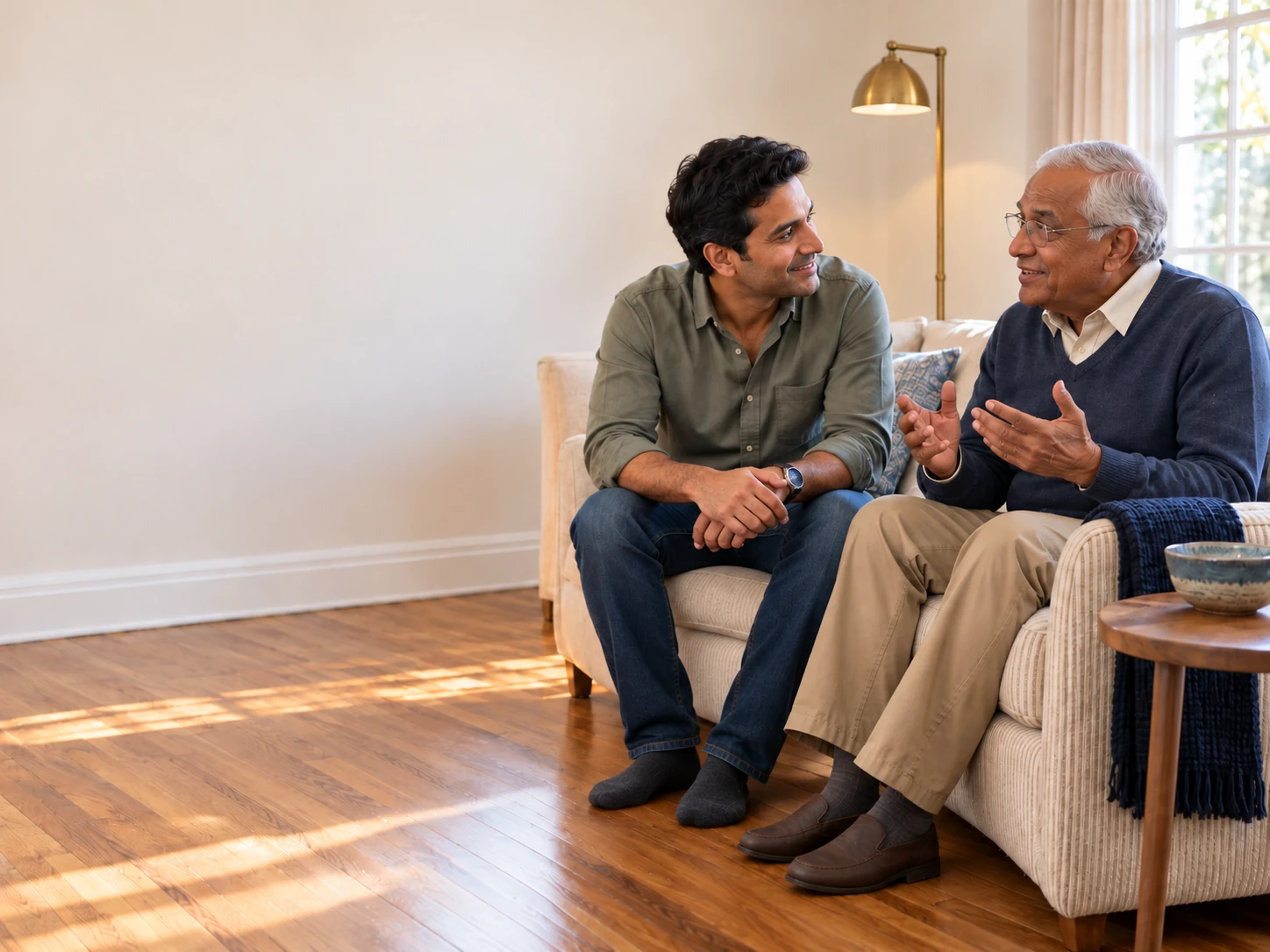 Adult son and senior father talking about home safety and aging in place at home