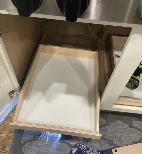 After — installed pull-out shelf extended from the cabinet