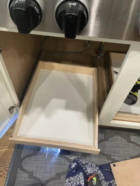 After — installed pull-out shelf extended from the cabinet